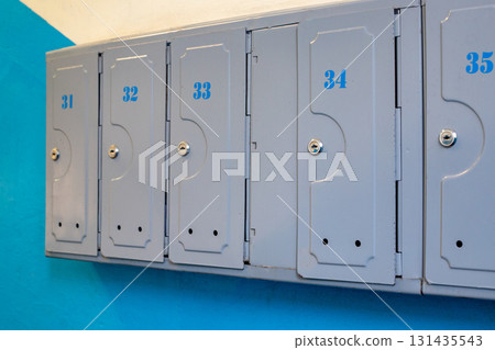 Apartments metal letter boxes close up. City flats entrance hall mailboxes. 131435543