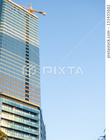 Modern construction of a high-rise building. Modern architecture of a business center. Apartment in a high-rise building. 131435682