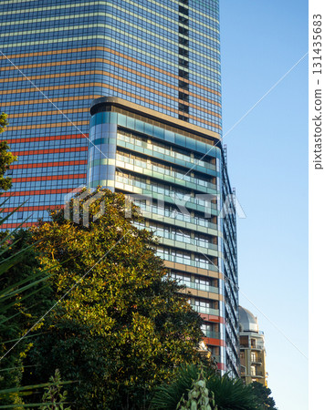 Modern construction of a high-rise building. Modern architecture of a business center. Apartment in a high-rise building. Modern construction of a high-rise building. Modern architecture of a business center. Apartment in a high-rise building. 131435683