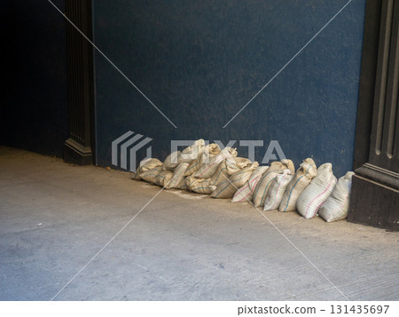 Bags of building materials in the corridor. Bags against the wall. Preparing for repairs. Bags of building materials in the corridor. Bags against the wall. Preparing for repairs. 131435697