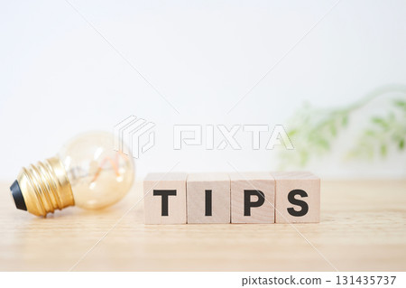 This stock photo is inspired by advice and tips, and is expressed using a light bulb and TIPS letter blocks. 131435737