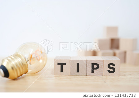 This stock photo is inspired by advice and tips, and is expressed using a light bulb and TIPS letter blocks. 131435738