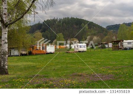 Vintage travel trailer in green campsite near Slapy lake in Czech Republic, panoramic view  131435819