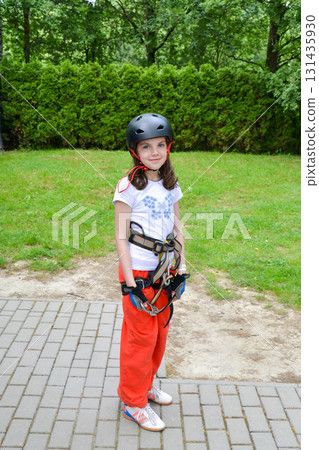 adventure climbing high wire park - people on course in mountain helmet and safety equipment. High quality photo adventure climbing high wire park - people on course in mountain helmet and safety equipment. High quality photo 131435930
