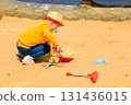 Boy and girl playing on the beach on summer holidays. Children building a sandcastle at the sea. High quality photo 131436015