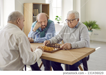 Group of senior men in retirement home sitting at table, playing chess and thinking Group of senior men in retirement home sitting at table, playing chess and thinking 131436020