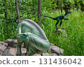 A dinosauris shown in a scene from the jurassic world. Dinosaur model in the park. Giant tyrannosaurus at an exhibition in the park 131436042