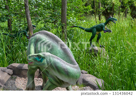A dinosauris shown in a scene from the jurassic world. Dinosaur model in the park. Giant tyrannosaurus at an exhibition in the park 131436042