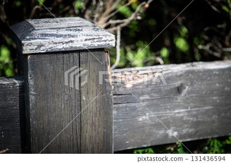Weathered Wooden Fence Post with Peeling Paint in Natural Outdoor Setting Weathered Wooden Fence Post with Peeling Paint in Natural Outdoor Setting 131436594