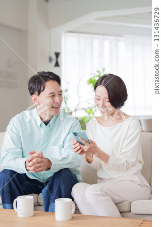 Couples looking at smartphones Couples looking at smartphones 131436729