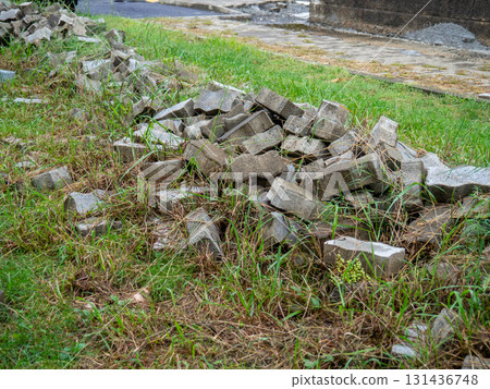 Renovation. Sidewalk renovation. Tiles on the grass. Construction Materials. Renovation. Sidewalk renovation. Tiles on the grass. Construction Materials. 131436748
