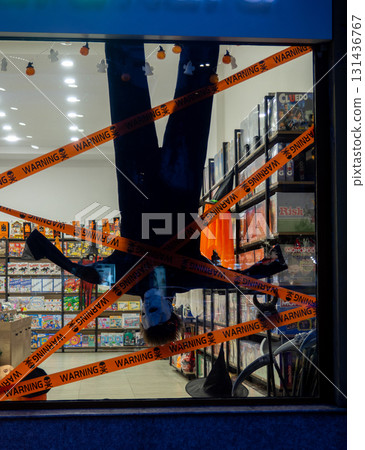 A scary figure for Halloween on a shop window. Bright advertising. Character from horror films. The figure is upside down. Halloween concept 131436767