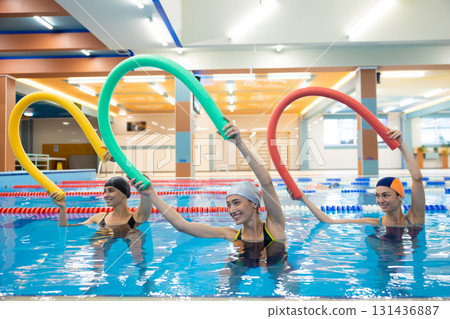 Women training with aqua noodles Women training with aqua noodles 131436887