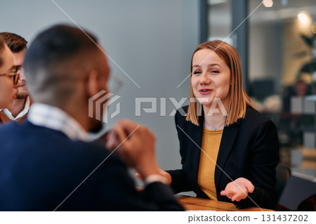 Businesswoman Leading Discussion in Modern Office Setting 131437202