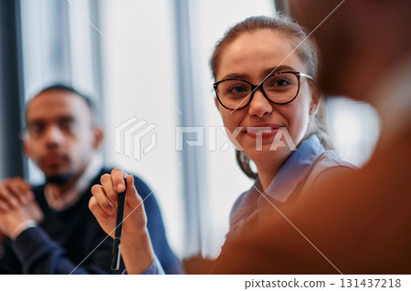 Businesswoman Leading Discussion in Modern Office Setting 131437218