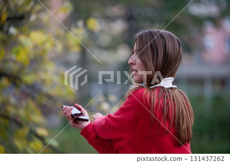 Athletic young woman taking a breath and relaxing after jogging and stretching. Woman Training and Workout Exercises On Street. Athletic young woman taking a breath and relaxing after jogging and stretching. Woman Training and Workout Exercises On Street. 131437262