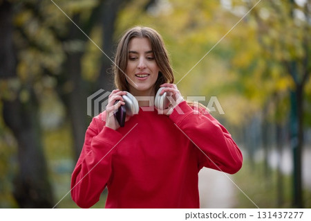 Athletic young woman taking a breath and relaxing after jogging and stretching. Woman Training and Workout Exercises On Street. 131437277