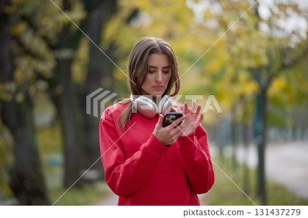 Athletic young woman taking a breath and relaxing after jogging and stretching. Woman Training and Workout Exercises On Street. 131437279