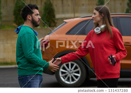 Car keys handshake, seller or car salesman and customer in a dealership, shake hands over the car keys Car keys handshake, seller or car salesman and customer in a dealership, shake hands over the car keys 131437280