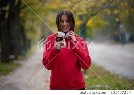 Athletic young woman taking a breath and relaxing after jogging and stretching. Woman Training and Workout Exercises On Street. 131437294