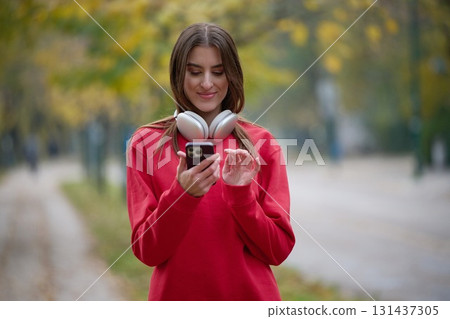 Athletic young woman taking a breath and relaxing after jogging and stretching. Woman Training and Workout Exercises On Street. 131437305