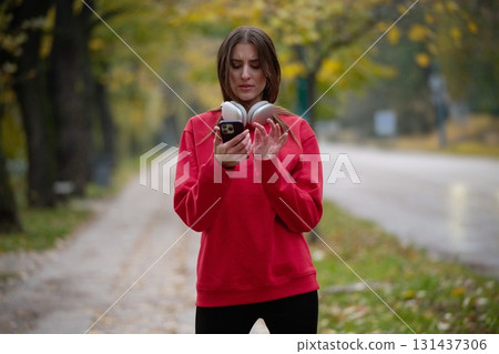 Athletic young woman taking a breath and relaxing after jogging and stretching. Woman Training and Workout Exercises On Street. Athletic young woman taking a breath and relaxing after jogging and stretching. Woman Training and Workout Exercises On Street. 131437306