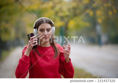 Athletic young woman taking a breath and relaxing after jogging and stretching. Woman Training and Workout Exercises On Street. Athletic young woman taking a breath and relaxing after jogging and stretching. Woman Training and Workout Exercises On Street. 131437320