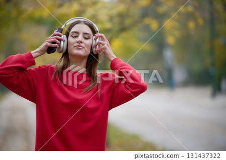 Athletic young woman taking a breath and relaxing after jogging and stretching. Woman Training and Workout Exercises On Street. Athletic young woman taking a breath and relaxing after jogging and stretching. Woman Training and Workout Exercises On Street. 131437322