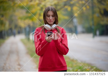 Athletic young woman taking a breath and relaxing after jogging and stretching. Woman Training and Workout Exercises On Street. Athletic young woman taking a breath and relaxing after jogging and stretching. Woman Training and Workout Exercises On Street. 131437325