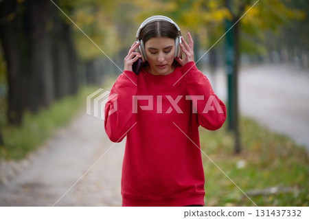 Athletic young woman taking a breath and relaxing after jogging and stretching. Woman Training and Workout Exercises On Street. Athletic young woman taking a breath and relaxing after jogging and stretching. Woman Training and Workout Exercises On Street. 131437332