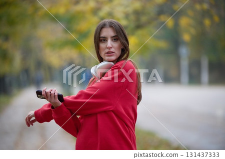 Athletic young woman taking a breath and relaxing after jogging and stretching. Woman Training and Workout Exercises On Street. 131437333