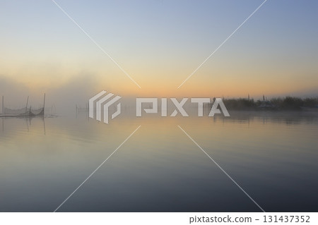 Sunrise over the misty Lake Inban 131437352