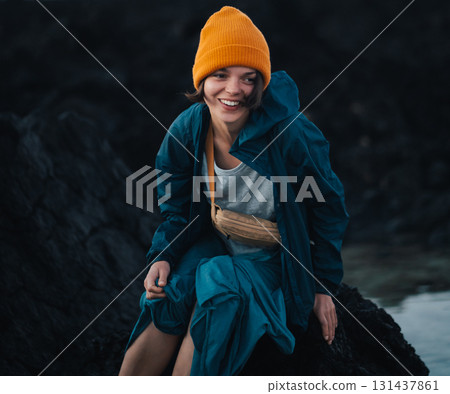 A girl enjoys a beautiful beach with black volcanic lava formations on the Canary islands. 131437861