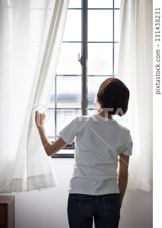 打開窗簾的女人的背影 131438231