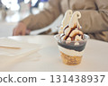 Hands of a woman eating ice cream 131438937