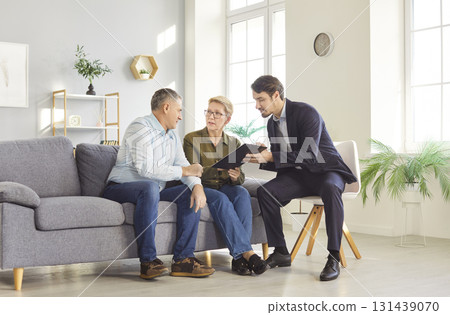 Senior Couple Meeting With Consultant At Home Senior Couple Meeting With Consultant At Home 131439070