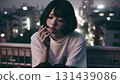 A woman smoking a cigarette 131439086