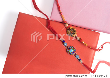 Colorful Rakhi bangles with decorative beads in wrapped gift boxes 131439571