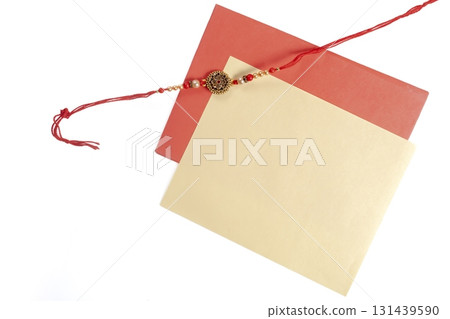 Festive Rakhi with red and yellow envelopes on a white background Festive Rakhi with red and yellow envelopes on a white background 131439590