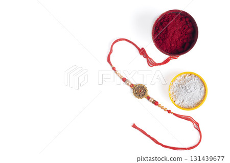 Rakhi bangle with red kumkum and white powder bowl for the festival Raksha Bandhan. 131439677