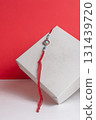 Beautiful Rakhi bangle in a gift box on a vibrant red background. 131439720