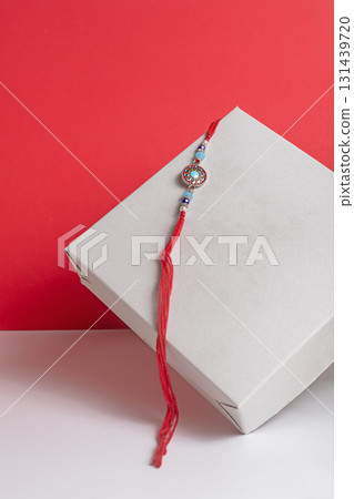 Beautiful Rakhi bangle in a gift box on a vibrant red background. Beautiful Rakhi bangle in a gift box on a vibrant red background. 131439720
