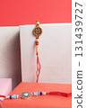 Elegant red beaded bracelet with an ornate gold pendant displayed in a gift box for a special occasion gift. 131439727