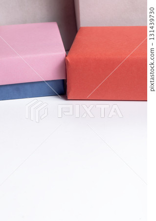 Colorful gift boxes with pink, orange and blue wrapping on a white surface for celebration and gifts. 131439730
