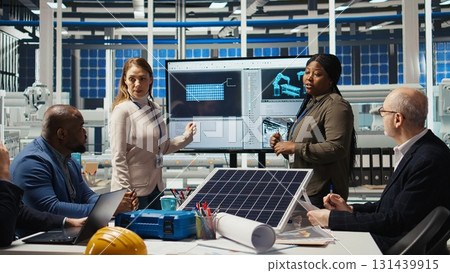 Shareholders meeting in photovoltaics plant, analyzing market trends to determine investment strategies. Managers brainstorming innovations, expanding factory production capabilities, camera A 131439915