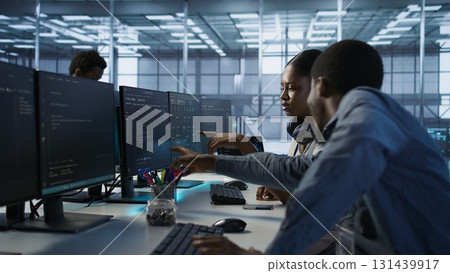 Engineer arrives in data center, puts headphones on, implementing AI systems. Server farm expert sitting down at desk, listening music and using artificial intelligence to prevent failures, camera A Engineer arrives in data center, puts headphones on, implementing AI systems. Server farm expert sitting down at desk, listening music and using artificial intelligence to prevent failures, camera A 131439917