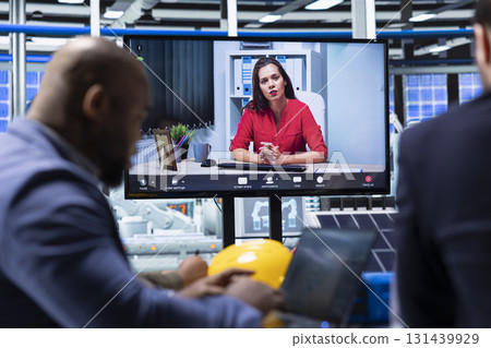 Factory manager doing online videocall meeting with investors to showcase manufacturing strategies. Executives doing teleconference with shareholders to show report of production growth opportunities 131439929