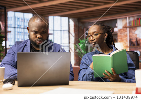 African american couple work on a management project for freelancing, using a laptop to research business trends and manage an online brand. Successful remote career development. African american couple work on a management project for freelancing, using a laptop to research business trends and manage an online brand. Successful remote career development. 131439974