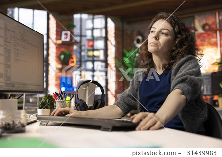 Female programmer developing an app and software algorithm on pc, working at the creative agency. Engineer uses digital tools and focuses on java script engineering and coding, IT specialist. Female programmer developing an app and software algorithm on pc, working at the creative agency. Engineer uses digital tools and focuses on java script engineering and coding, IT specialist. 131439983