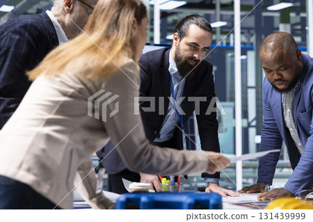 Industrial factory management executives discussing solar panel automation strategies in office. Production plant team analyzing data to enhance sustainable manufacturing processes Industrial factory management executives discussing solar panel automation strategies in office. Production plant team analyzing data to enhance sustainable manufacturing processes 131439999